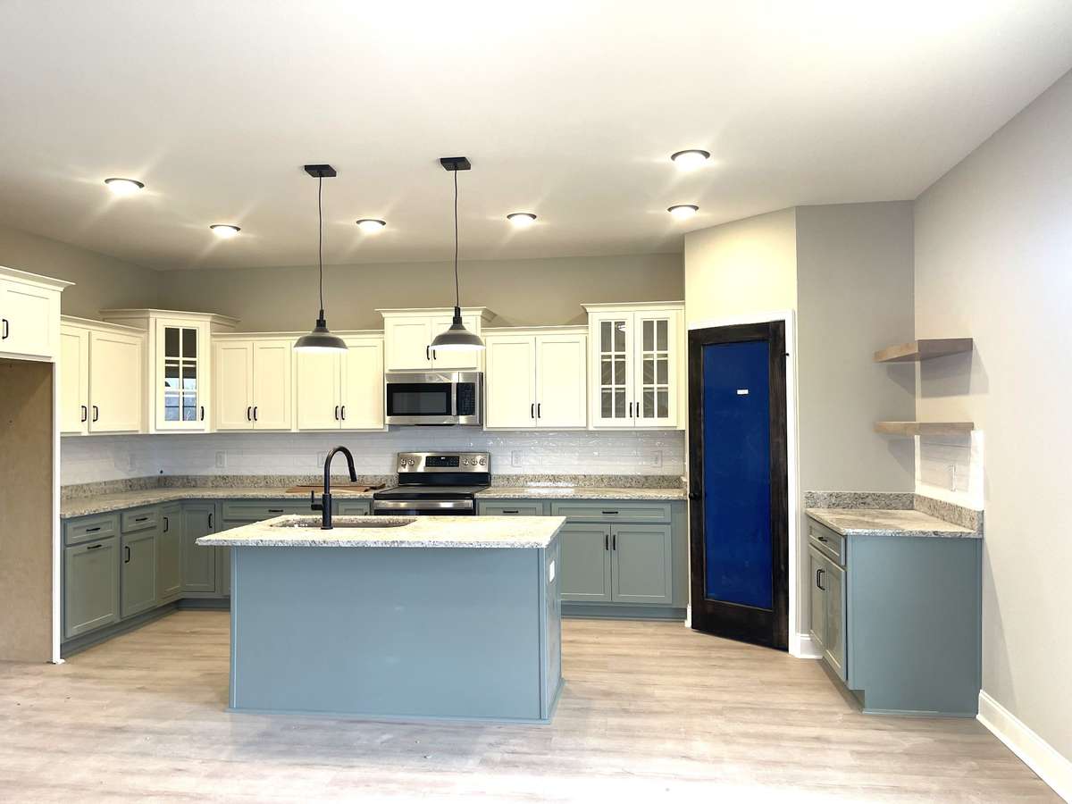 Check out this awesome Kitchen complete with accent glass door cabinets, soft close doors & drawers, granite tops, corner Pantry, GE Stainless Appliances, Coffee Niche and Laminate Flooring!!!   WOW