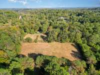 Tons of cleared out land for entertaining behind the property for outdoor activities!