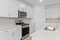 Kitchen
(photo is of a finished similar home- options and colors may vary in actual home)
