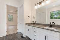 Primary bathroom with large oversized shower, freestanding tub and quartz countertops.