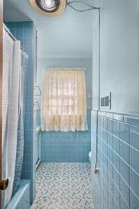 Full Bath with Tub/Shower combo in hall way.