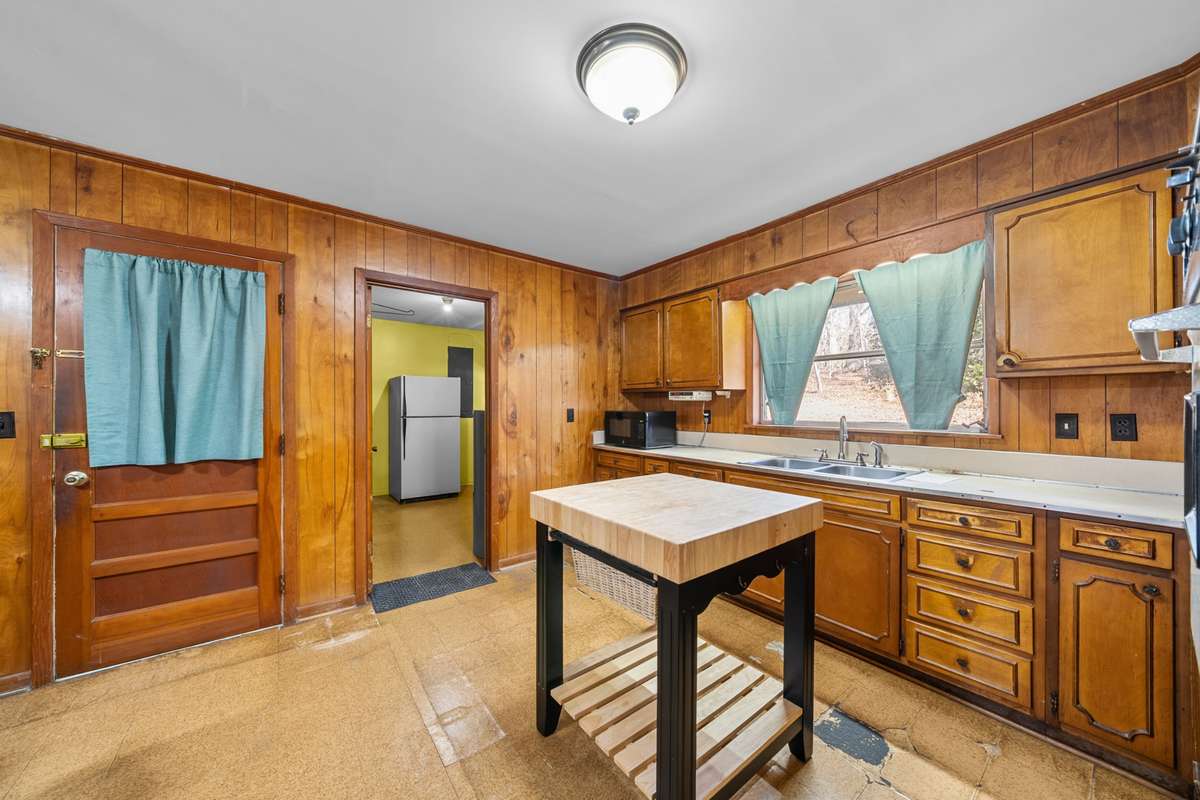 Kitchen with access to carport and laundry room