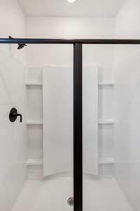 A shower big enough to accommodate storage for all your bottles! Actual photo of home.