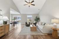 Freshly painted and filled with light, this living room features upgraded laminate wood-look flooring and new modern light fixtures, creating a stylish, welcoming space to gather, relax, or entertain.