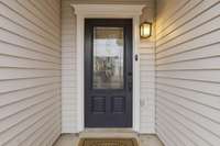 A warm and welcoming first impression—this inviting front door sets the tone for the beautifully updated home that awaits inside.