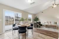 Light-filled eat-in kitchen and living room with an open layout and abundant natural light, creating a bright, inviting space for daily living and entertaining.