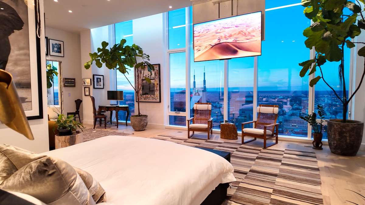 A motorized Future Automation 75-inch ceiling-mounted Samsung TV in the primary suite.