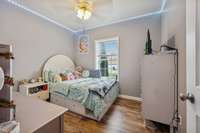 Spacious bedroom with ceiling fan and room for multiple furniture configurations.