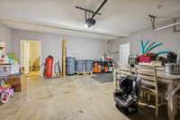 Attached two car garage with extra depth and access to a large storage area.