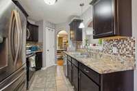 Alternate kitchen angle showing pantry storage and connection to the breakfast nook.