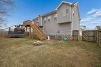 Rear yard view showing deck access and open grassy space.
