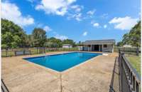 Fenced, in-ground pool with pool house