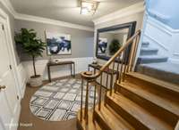 Virtually enhanced to show potential. There also a coat closet to the right side of the stairs.