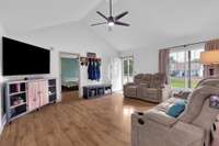 Living Room view looking at front door and into Primary Bedroom