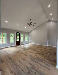 The large livingroom from a previous build. The buyer was able to pick their flooring, paint and light fixtures because they contracted early. Beautiful!