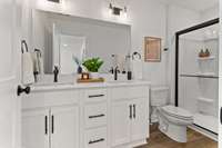 Photos of similar listing - home is under construction. Primary bathroom features double vanities