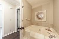 Guest bathroom features a large soaking tub, perfect for relaxing at the end of the day.