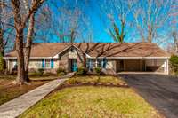 Nestled on a quiet cul-de-sac, the front exterior is framed by beautiful mature trees, creating a private, peaceful setting from the moment you arrive.