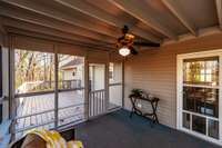 The screened porch is perfect for morning coffee, evening lounging, or bug-free outdoor dining.