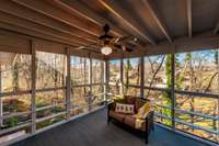 Spacious screened-in deck offers a peaceful place to relax while enjoying views of the private, tree-lined backyard.