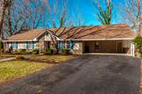 Set on a spacious .56-acre lot, the front yard provides ample space and natural beauty with towering trees and a serene atmosphere.