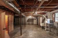 Large unfinished area offers excellent storage potential or space for a workshop.