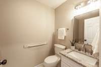 White cabinetry and granite countertops give the guest bath a clean, updated look.