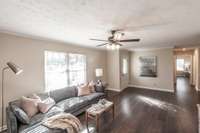 The generous size of this living room allows for multiple seating areas, making it perfect for both relaxing and entertaining.