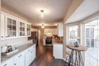 Natural light enhances the bright finishes, creating a warm and welcoming kitchen environment.