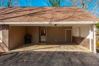The attached carport offers convenient covered parking while blending seamlessly into the home’s timeless exterior design.