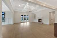 Living Room w/ Gas Fireplace, Coffered Ceilings & Access to Covered Patio