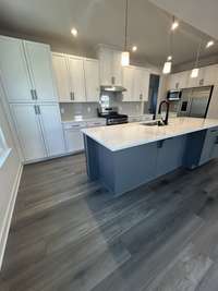 Goumet Kitchen with quartz countertops, black matte fixtures, upgraded gas range and all appliances.