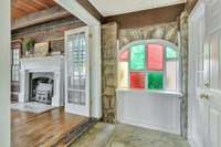 View into large front living room and of the colored glass in the hallway.