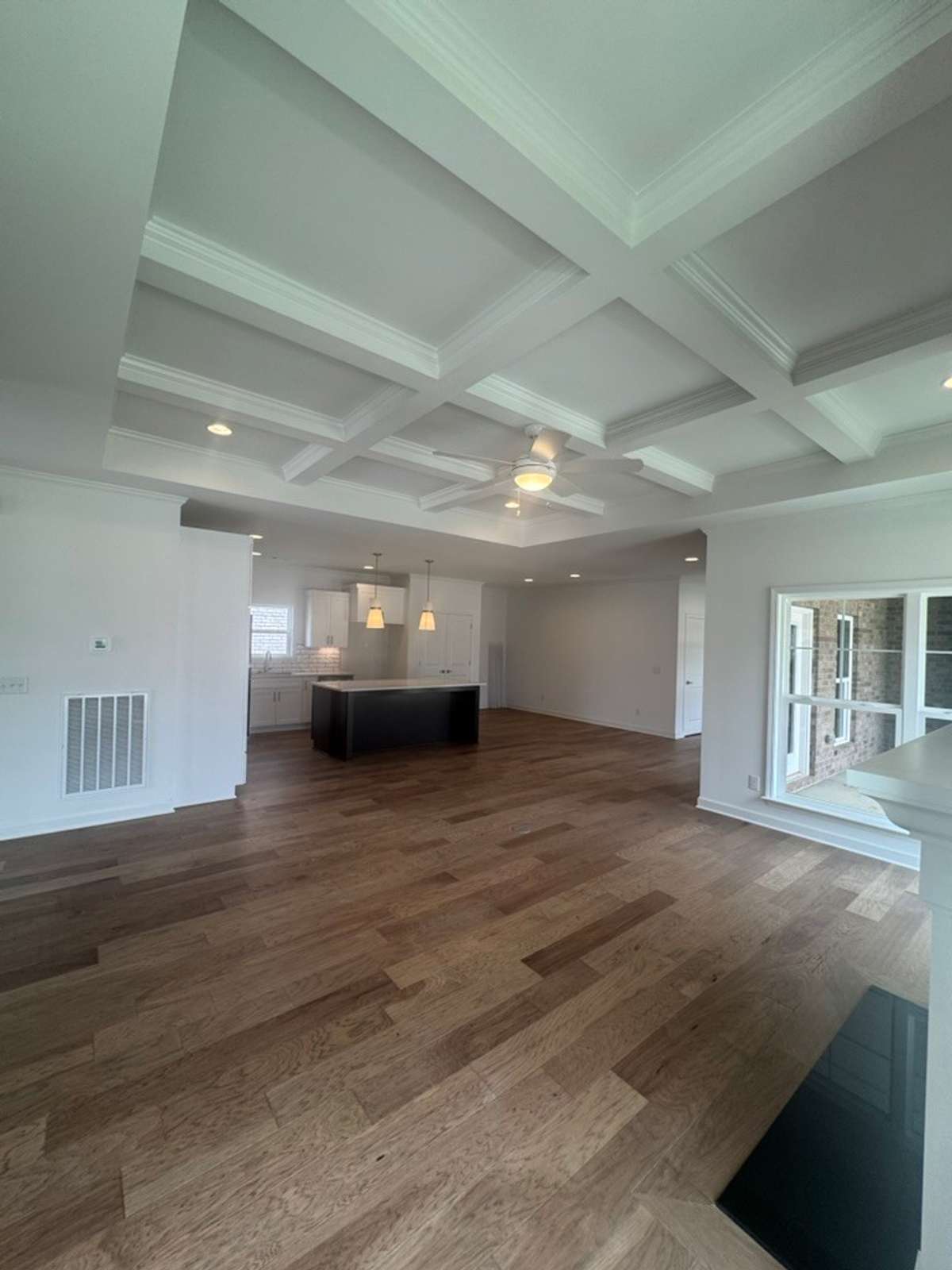 Beautiful open living/dining/kitchen layout with a coffered detail ceiling
Previously built home, options and selections may vary