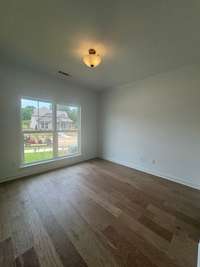 Main level guest bedroom with a walk-in closet
Previously built home, options and selections may vary