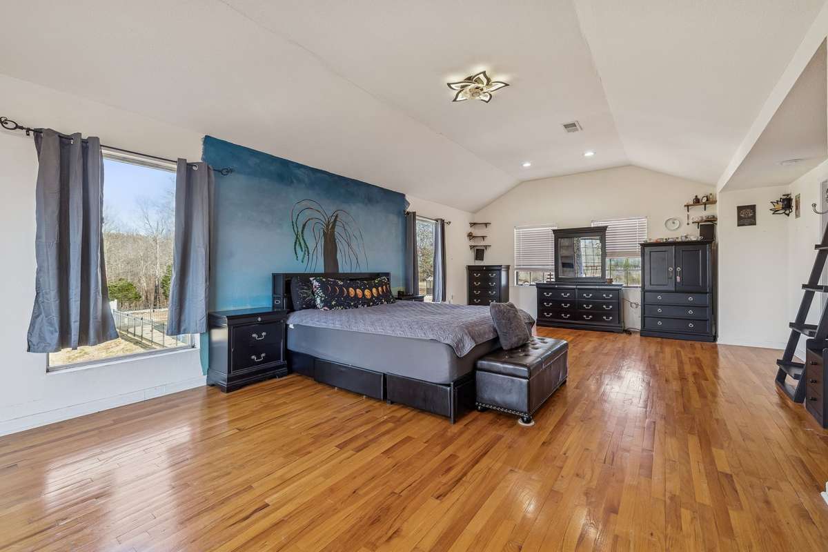 The owner's suite has ample space for a bed, sitting area, and more.  This was supposed to be the owner's forever home before a job transfer changed that, so mural can be completed prior to closing or painted to match the rest of the room.