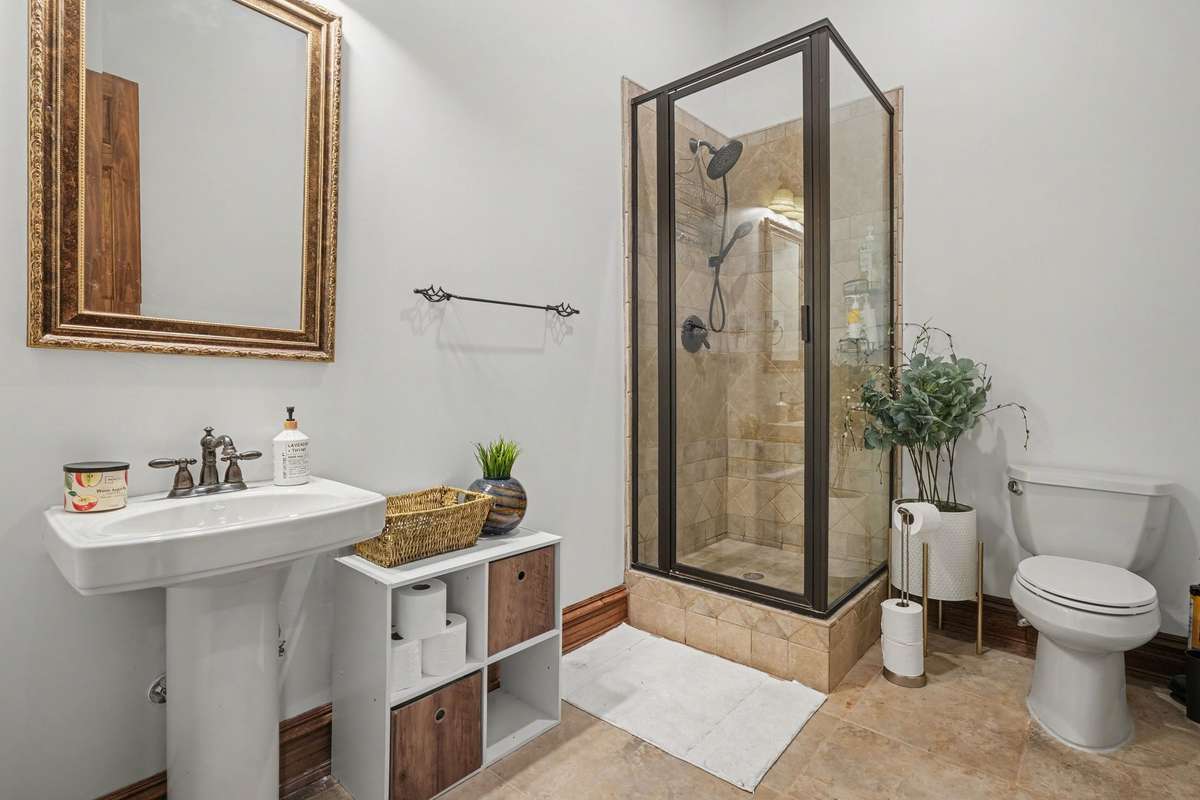 Downstairs full bathroom accessible by door for wet swimmers coming in and out from pool. RV garage entrance on same hallway