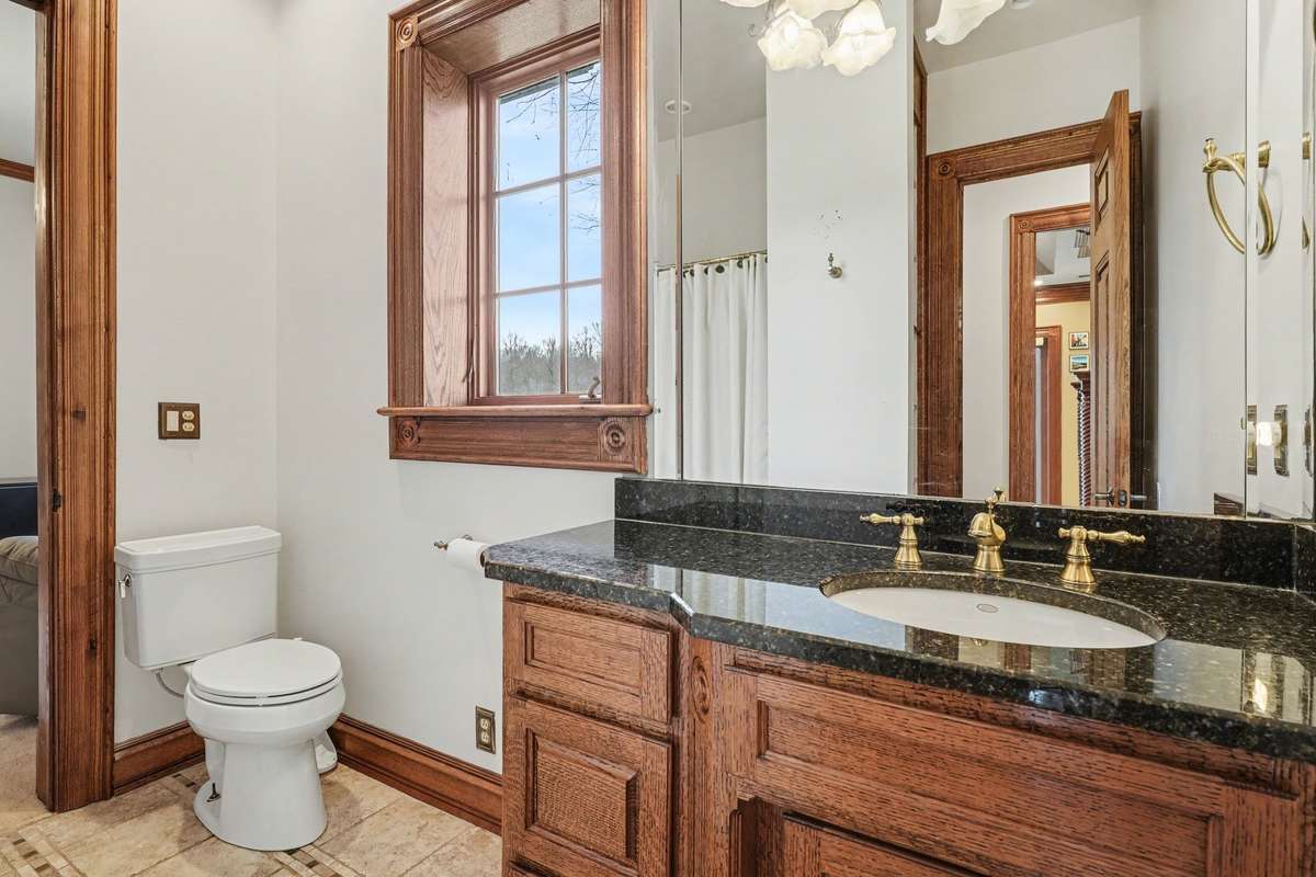 Full bath next to office, across from primary bedroom. There is a bedroom attached to this bathroom (not shown)
