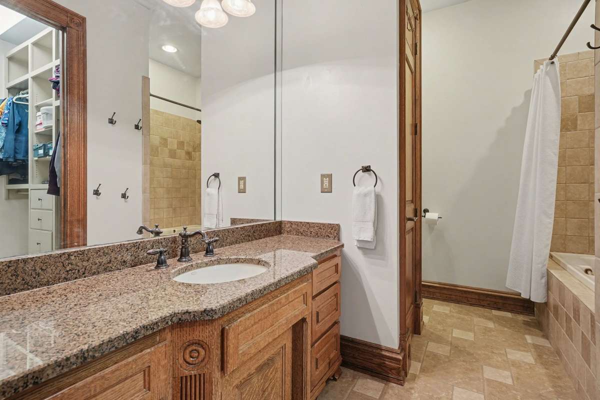full bath off bedroom with walk in closet tub/shower combo