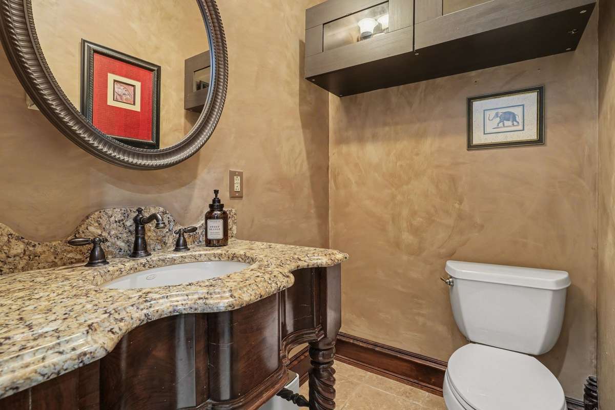 Half bath off of kitchen near laundry room and garage entrance
