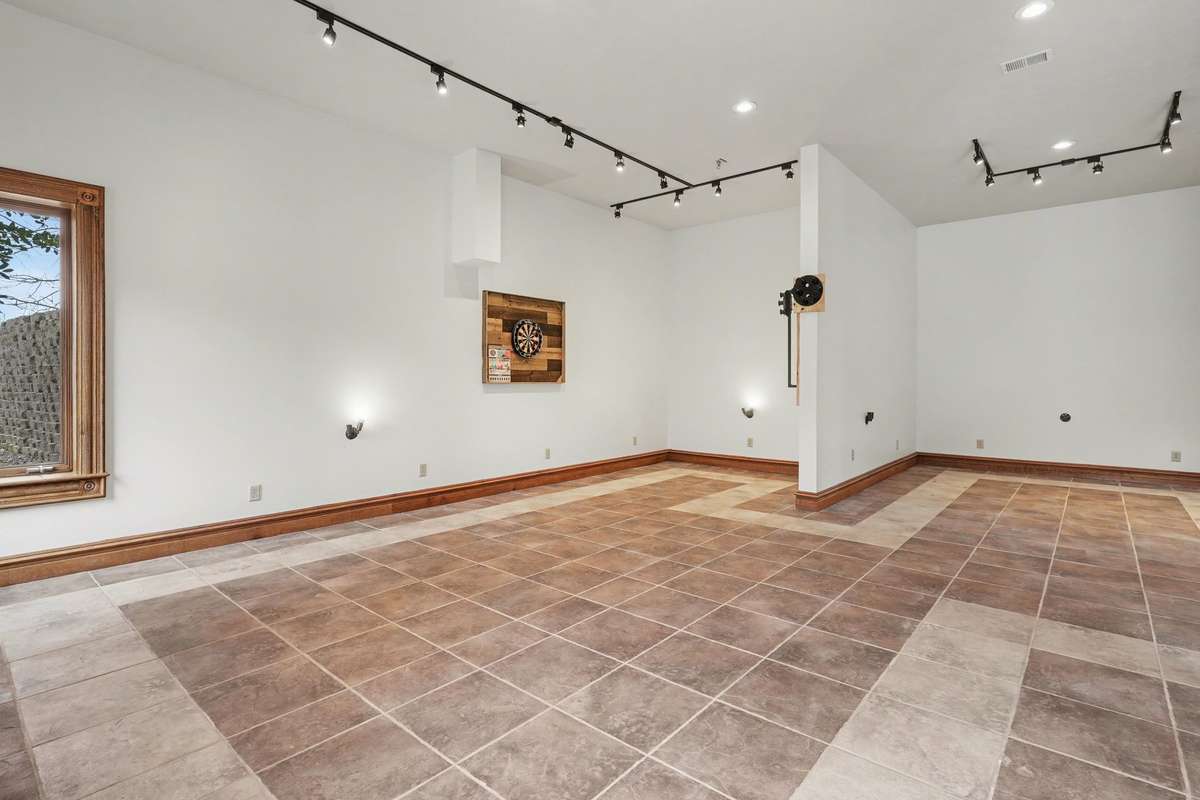 4000 sq ft basement with double sided fireplace and bar area.  Track lighting and up lighting used be previous owner to highlight precious collections. Basement walks to to patio area and pool
