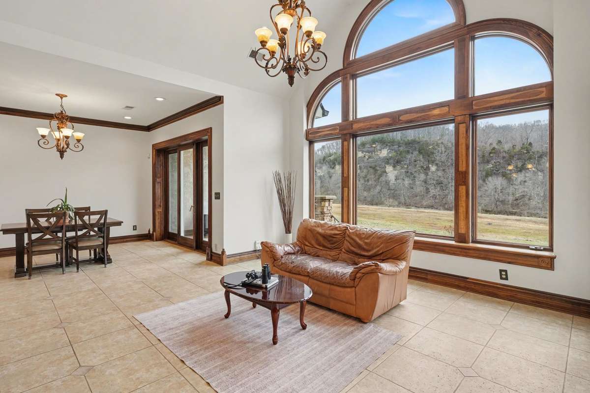 Den- Large picturesque windows, couch facing into kitchen.  Breakfast area with doors to out door patio.  Bird watching galore.