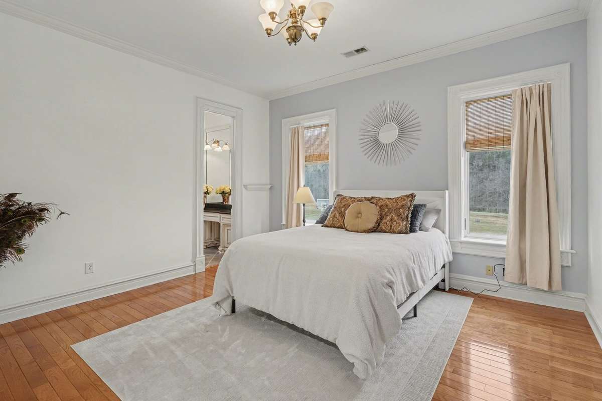 Bedroom at back of home with large closet, en suite bathroom, tub/shower combo