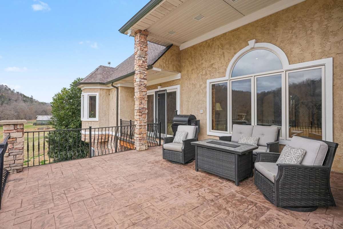 Patio outside living room overlooking pool and bluffs