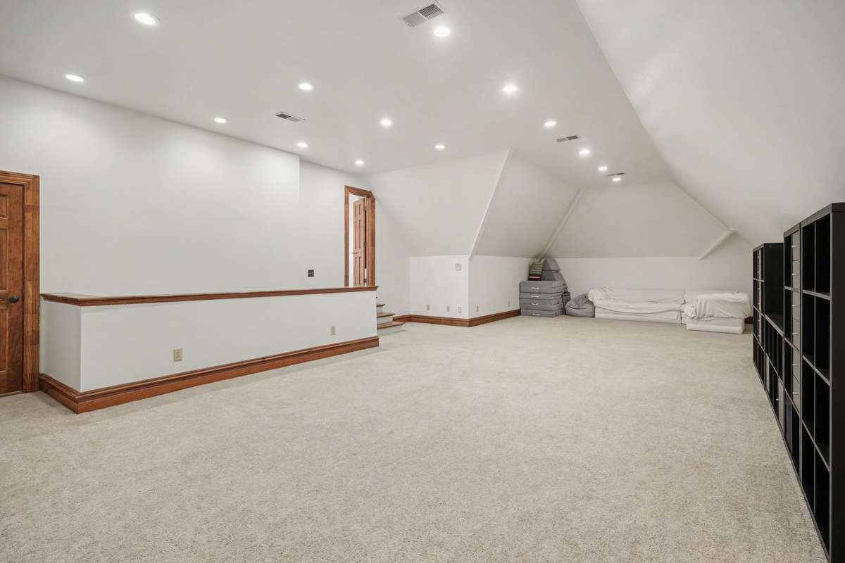 large bonus room upstairs. Far Left door leading to storage. left door by stair entrance leads to nook.