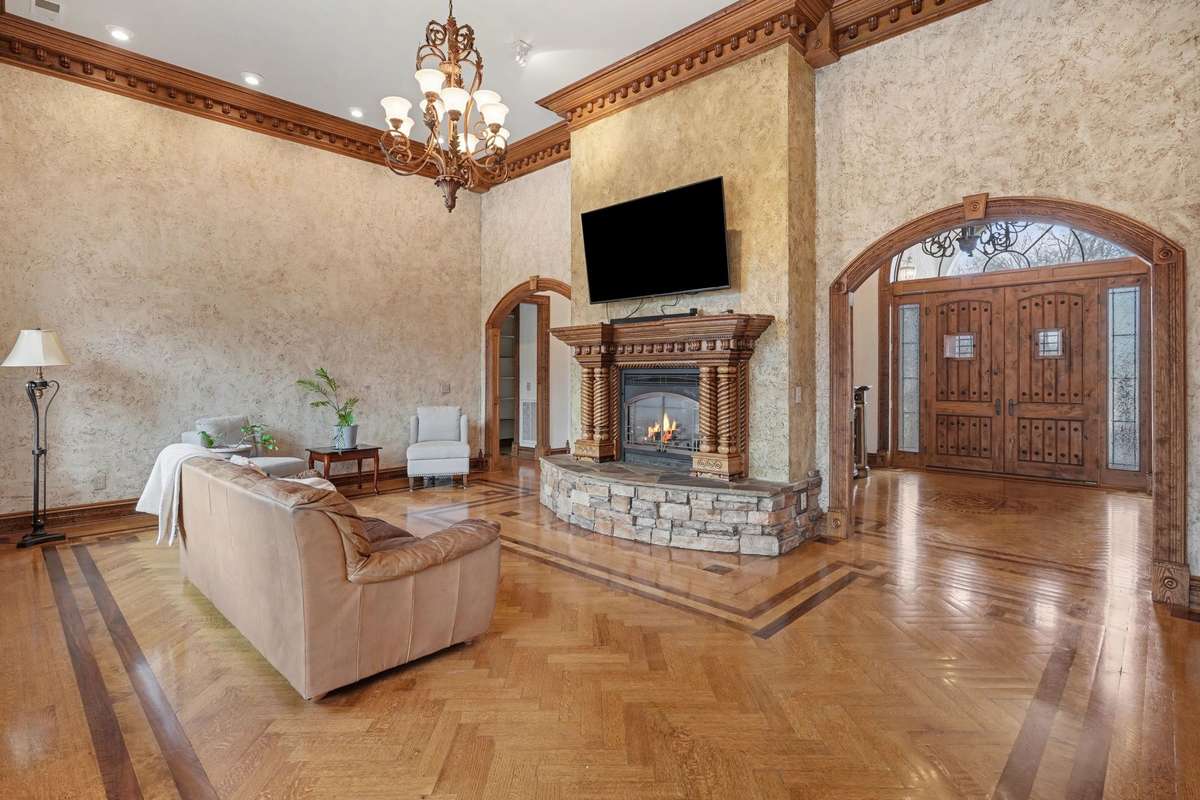 Living Room with custom millwork molding, herring bone floors and fireplace.