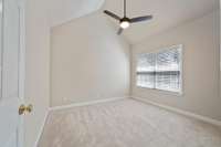 Secondary bedroom is also spacious and featues new carpeting, new ceiling fan with remote, and private bath/closet