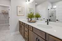 Enjoy luxury every day in your primary suite! Double vanities, ceramic tile, and raised height vanities are included. Choose between a separate tub and tiled walk-in shower or tiled walk-in shower with linen closet at NO COST!