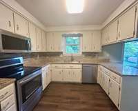 Remodeled kitchen with stainless steel appliances, backsplash and granite counter tops.