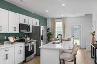 Photo of similar, staged model home. Fantastic kitchen, and designated dining space!
